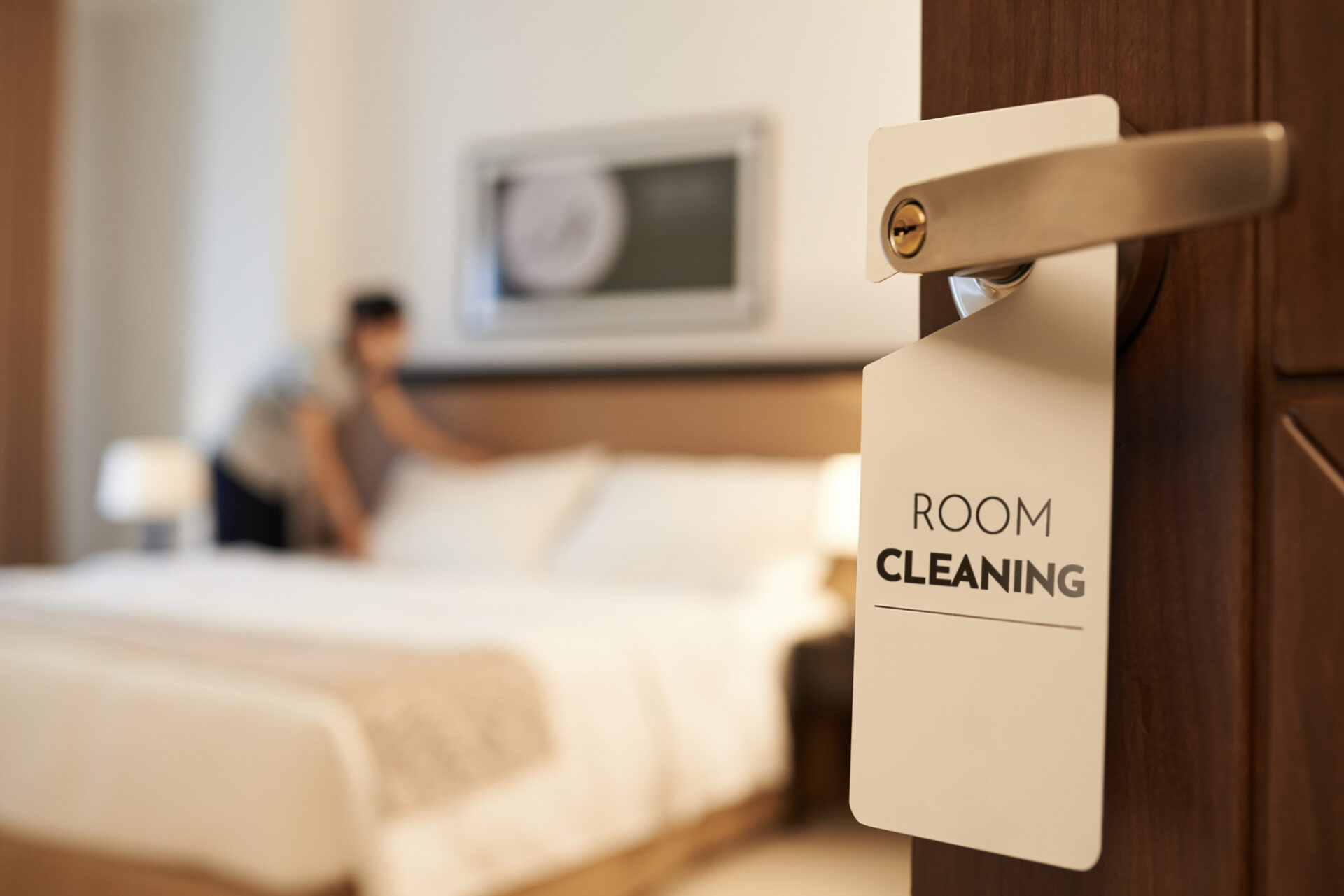 客室清掃をしている清掃員とドア札